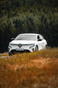 Framed Print : A white car drives through a beautiful meadow landscape surrounded by trees