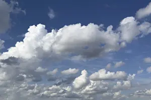 White clouds cumulus heap clouds in front of blue sky