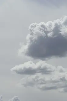 White cumulus clouds, grey sky, Germany