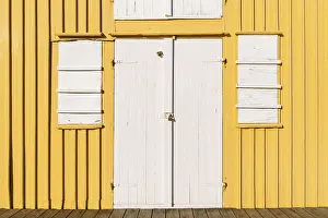 White door and window, front side yellow boathouse
