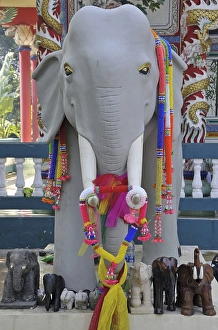 White elephant statue decorated in artificial flower garlands
