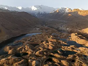White glaciated and snowy mountain peak Pik Lenin at sunrise