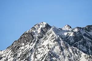 White mountain top with blue sky