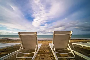 Empty white plastic sunbeds on Tsilivi Beach in summer on Zante Island