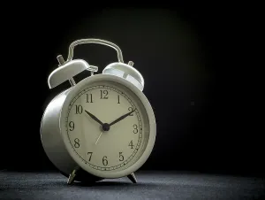 White retro alarm clocks on black background