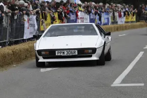 A white sports car drives on a race track