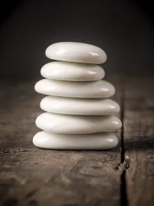 White stacked stones on a rustic wooden table