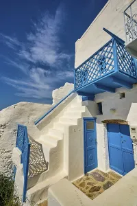 White staircase with blue railing and doors