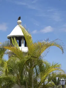 White tower with a bird on top