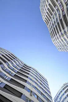 Wide angle shot of new apartments buildings exterior at the background of clear blue sky