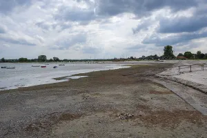 A wide beach under a cloudy sky