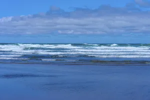 Wide, blue sea with gentle waves under a cloudy sky