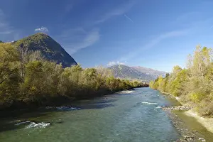 Wide river snakes through an autumnal valley
