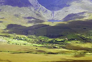 Wide valley in a mountain landscape with different shades of green and shadow