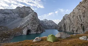 Wild camping, camping in the wilderness with a tent in front of mountain lake Kol Suu