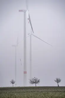 Wind farm in fog, dark doldrums