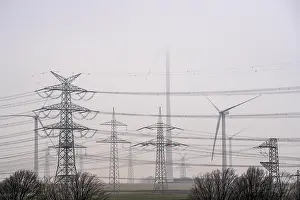 Wind farm in the fog, high-voltage pylons