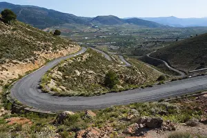 Winding road through a green mountain landscape to Mirador Laujar