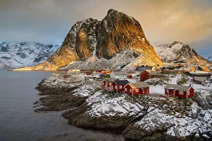 Winter Scandinavian landscape with illuminated red houses