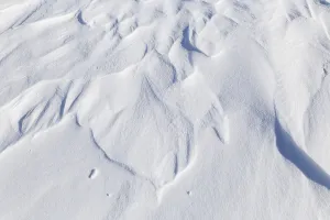 Winter, snowdrift pattern on a frozen river