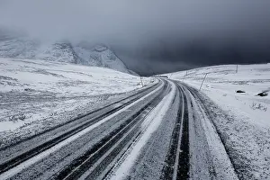 Winter storm, dark clouds above the pass road Rekvikvegen