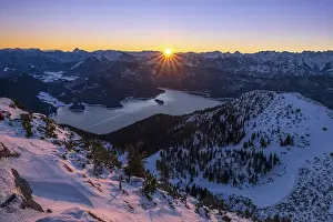 Winter sunrise over Lake Walchen with view of the Alps