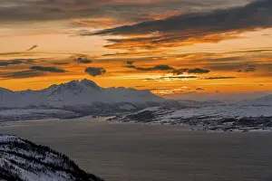 Winter view from Mount Storsteinen to the island of Kvaloya with the mountains at sunset