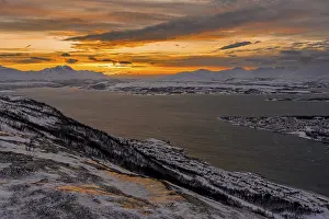 Winter view from Mount Storsteinen to the southern tip of Tromso at sunset