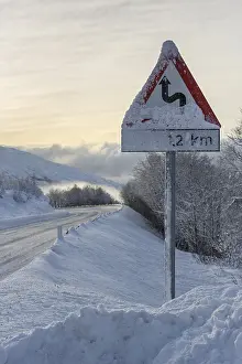 Wintry road with warning sign, European route E10
