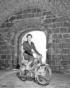 Woman of the 1950s. A young woman with a new Monark moped 1956