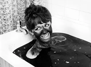 Woman bathing in mud, England, Great Britain