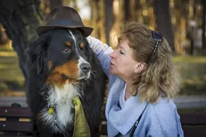Woman with bernese mountain dog on nature