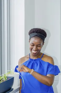 Woman in a blue blouse smiling playfully