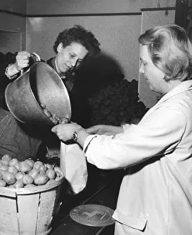 Woman buys potatoes, 1960s, Germany, Europe