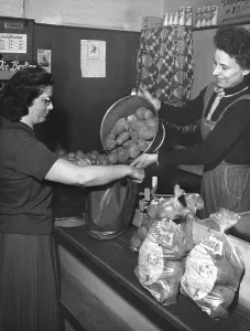 Woman buys potatoes, 1960s, Germany, Europe