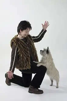Woman with Cairn Terrier, dancing dog