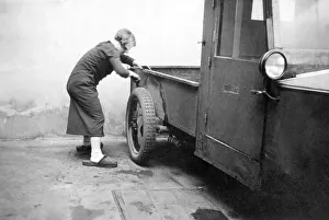 Woman cleaning a car, historical image, ca. 1929