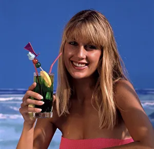 Woman with cocktail by the sea