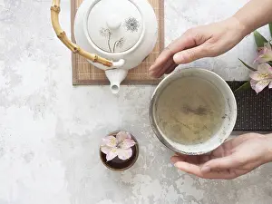 Framed Print : Woman gently holding a tea bowl during a traditional japanese tea ceremony