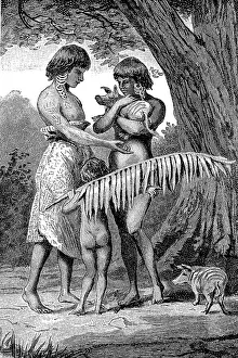 Woman and girl with a piglet in their arms from Yos Sudarso Bay