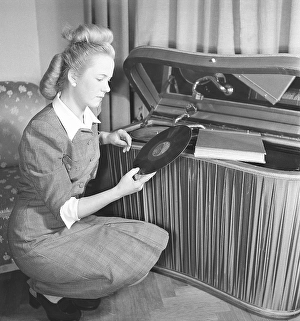 Woman at a gramophone in the 1940s