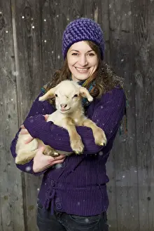 Framed Print : Woman holding a lamb in her arms