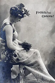 Woman holding nest with young bird