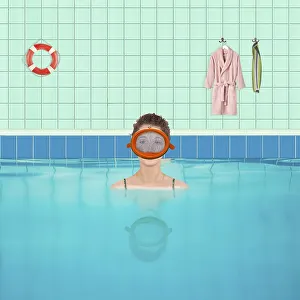 Woman in indoor swimming pool with diving goggles