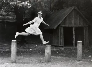 Woman jumps from peg to peg, 1930s