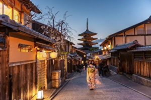 Woman in kimono in a lane, Yasaka dori historical alleyway in the old town with traditional Japanese houses