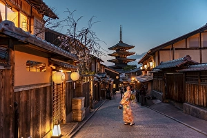 Woman in Kimono posing in an alley