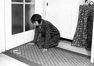 Woman kneels on the ground in front of an apple peel ca