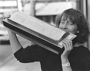 Woman with large harmonica, England, Great Britain
