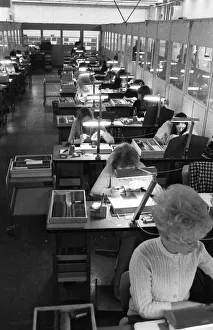 Many woman and a few men work at jobs at Standard Elektrik Lorenz (SEL)